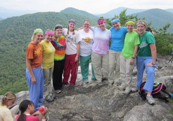 Camp leaders posing together at the top of a mountain peak called Pinnacle Knob in Clayton, Georgia.